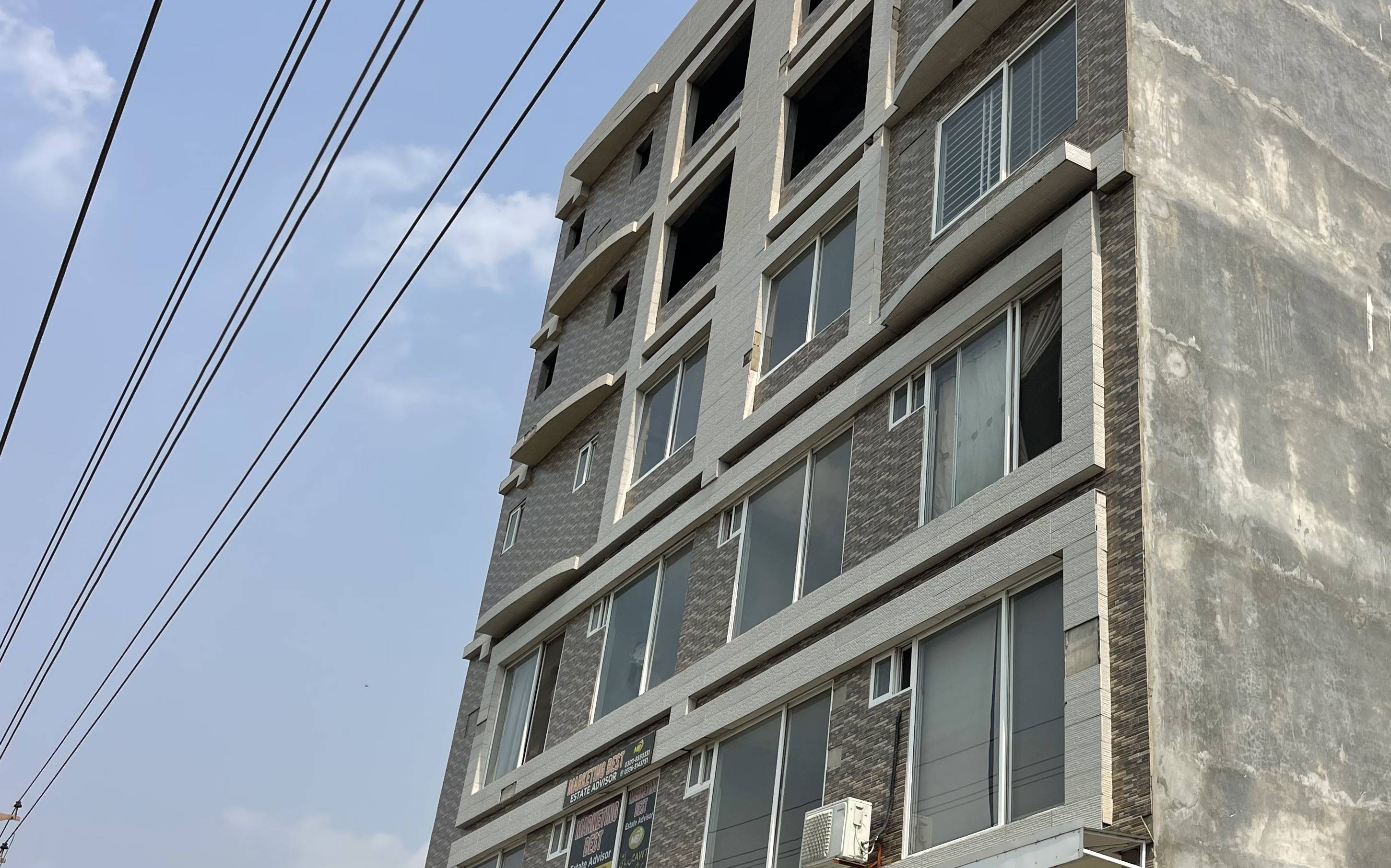 Close-up of the brick and tile facade at AH Arcade Apartments