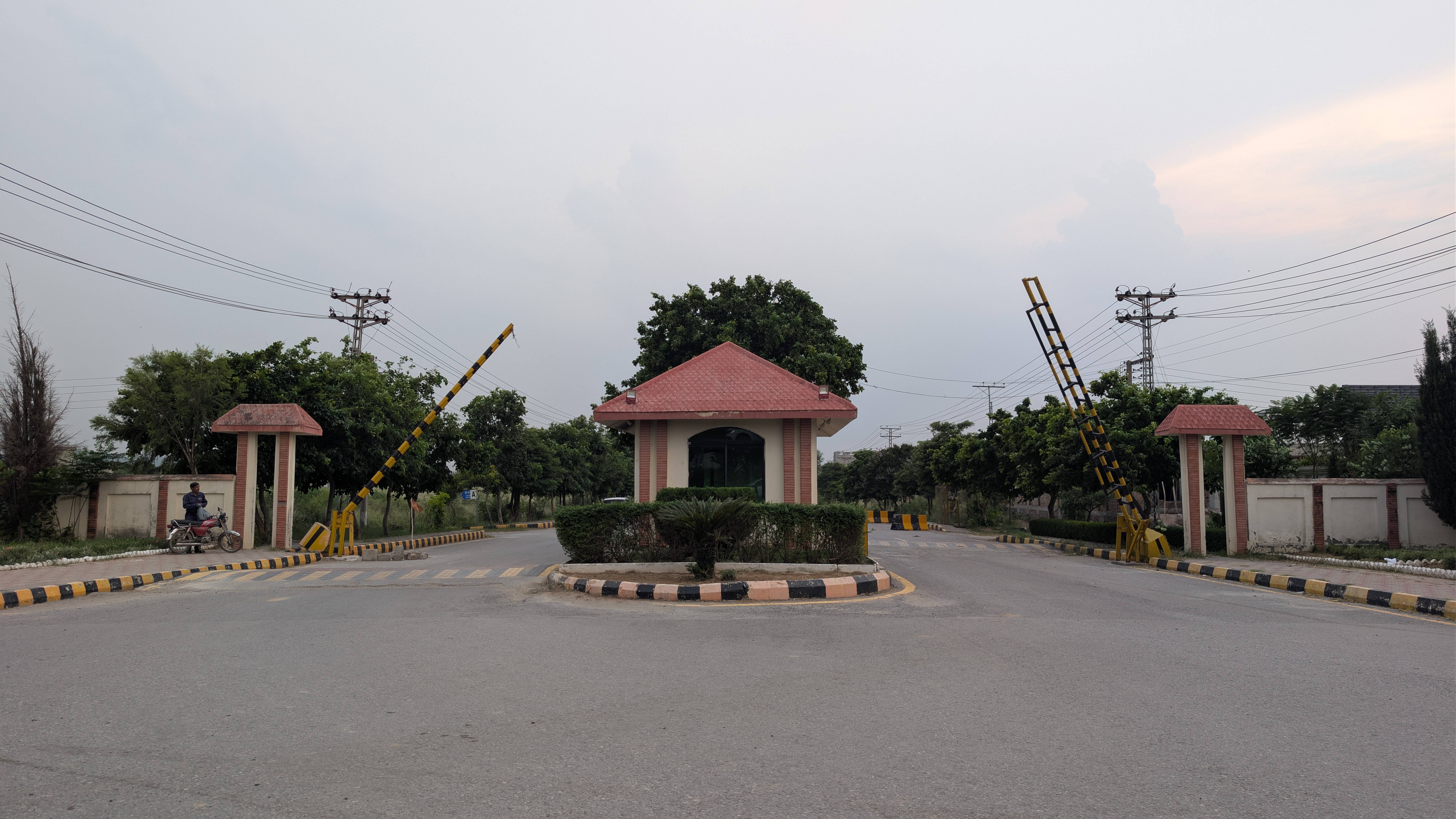 The tree-lined entrance gate to AWT D-18, Islamabad