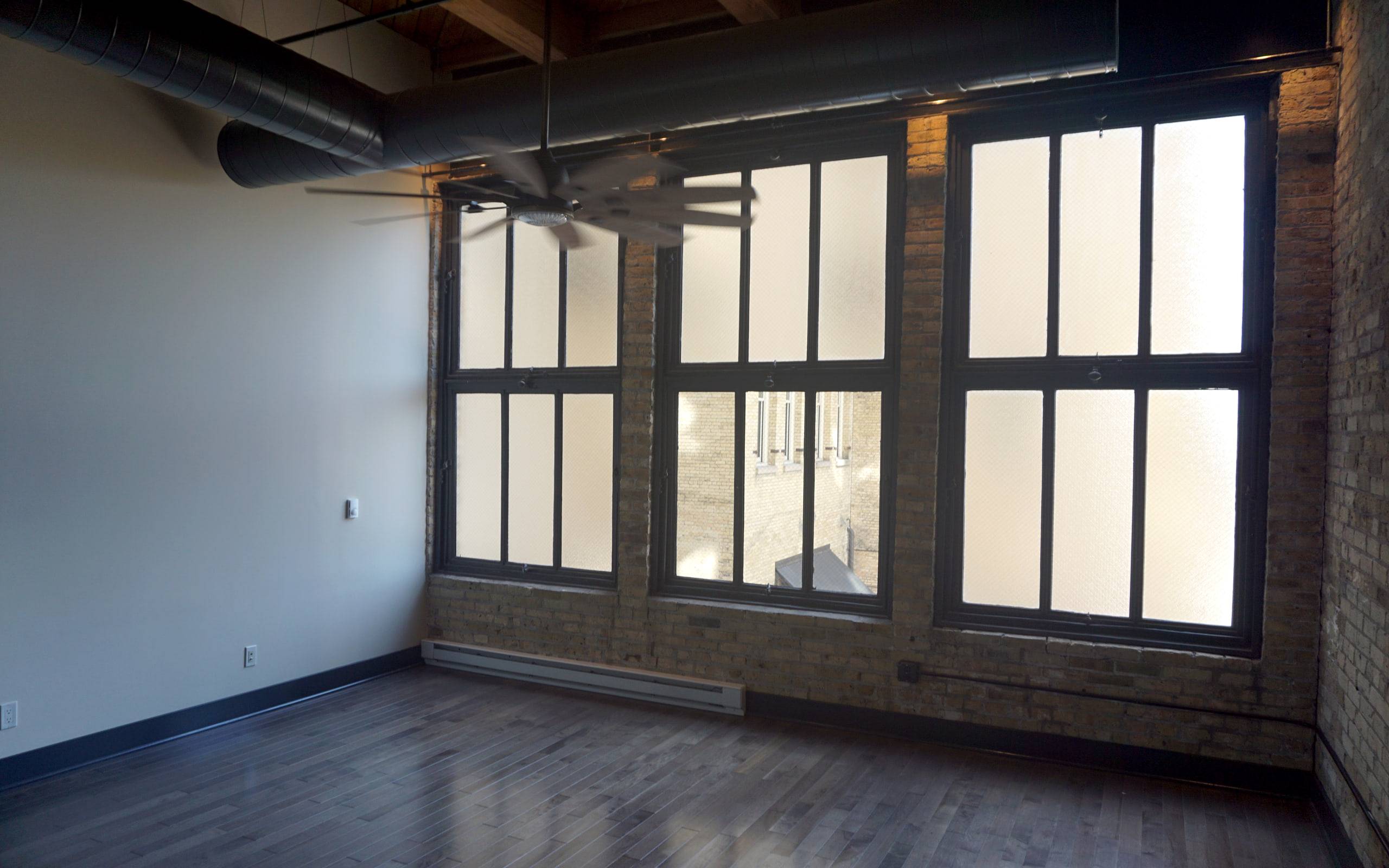 A bright open interior with tall industrial windows