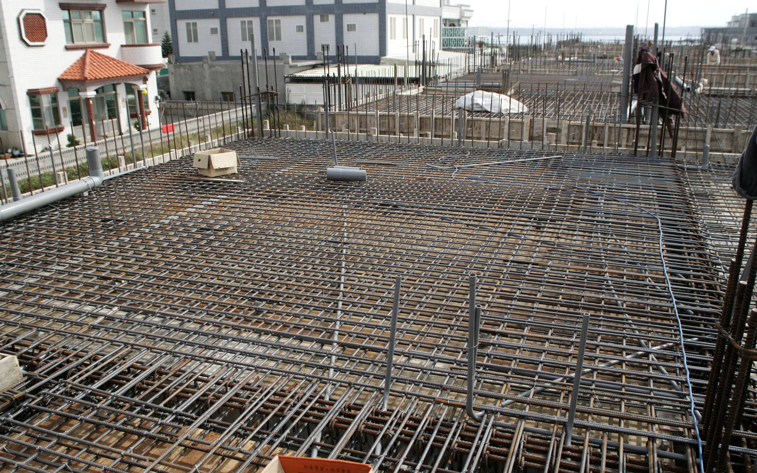 Reinforcement steel laid out on a construction site before the pour